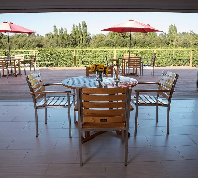 A table and chairs set up outside in the sun.